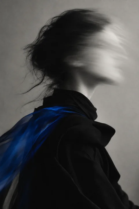 A profile in black and white, the face dissolving into motion blur