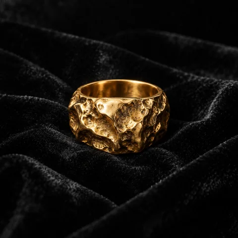 A heavy gold ring on black velvet